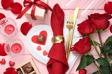 Photo of Flat lay composition with romantic place setting for Valentine's day on pink wooden table