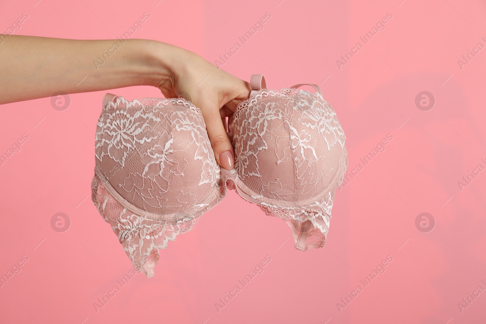 Photo of Woman with lace bra on pink background, closeup