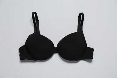 Photo of Beautiful black bra on white background, top view