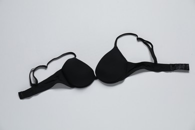 Photo of Beautiful black bra on white background, top view