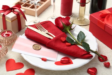 Romantic place setting with red rose on table, closeup. Valentine's day celebration