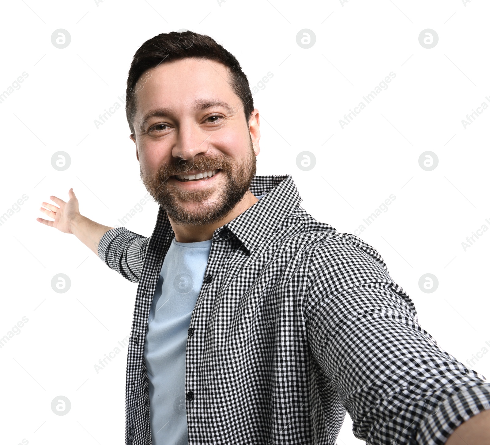 Photo of Happy man taking selfie and welcoming friends or guests on white background