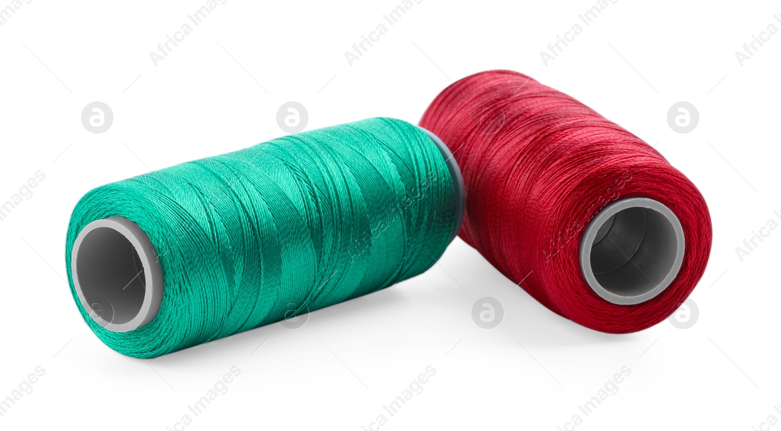 Photo of Spools of bright sewing threads isolated on white