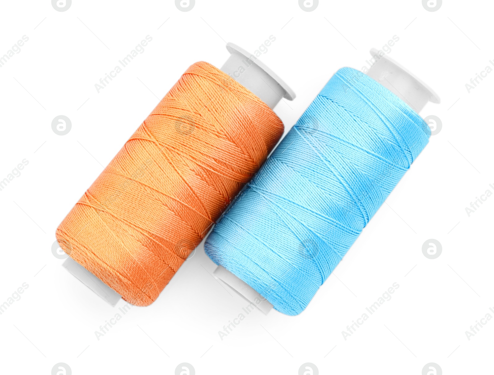 Photo of Spools of bright sewing threads isolated on white, top view