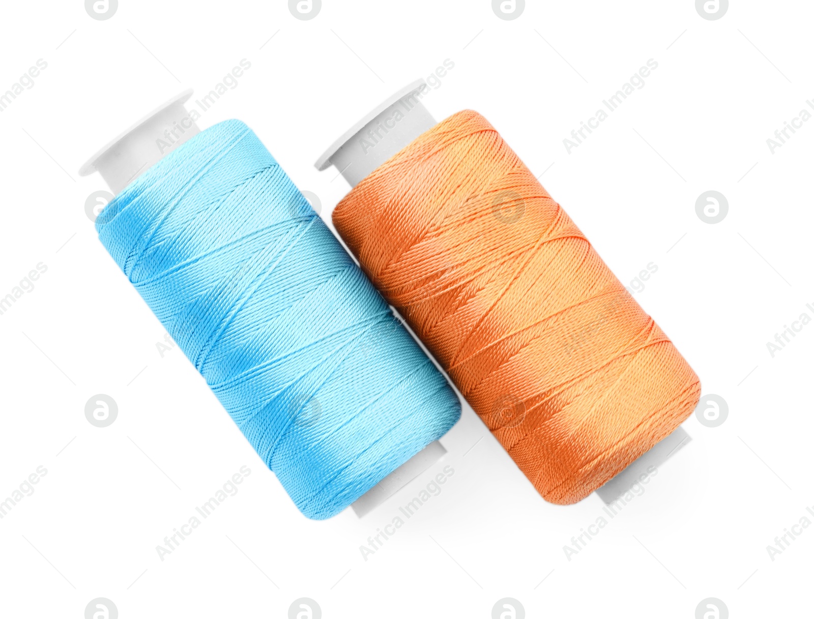 Photo of Spools of bright sewing threads isolated on white, top view