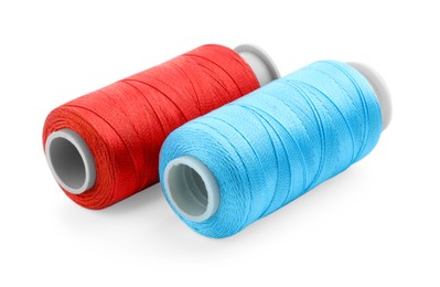 Photo of Spools of bright sewing threads isolated on white