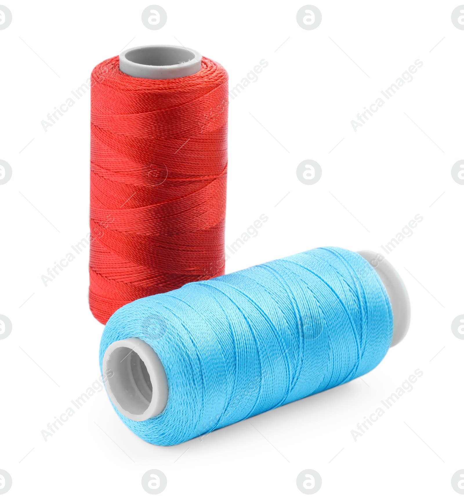 Photo of Spools of bright sewing threads isolated on white