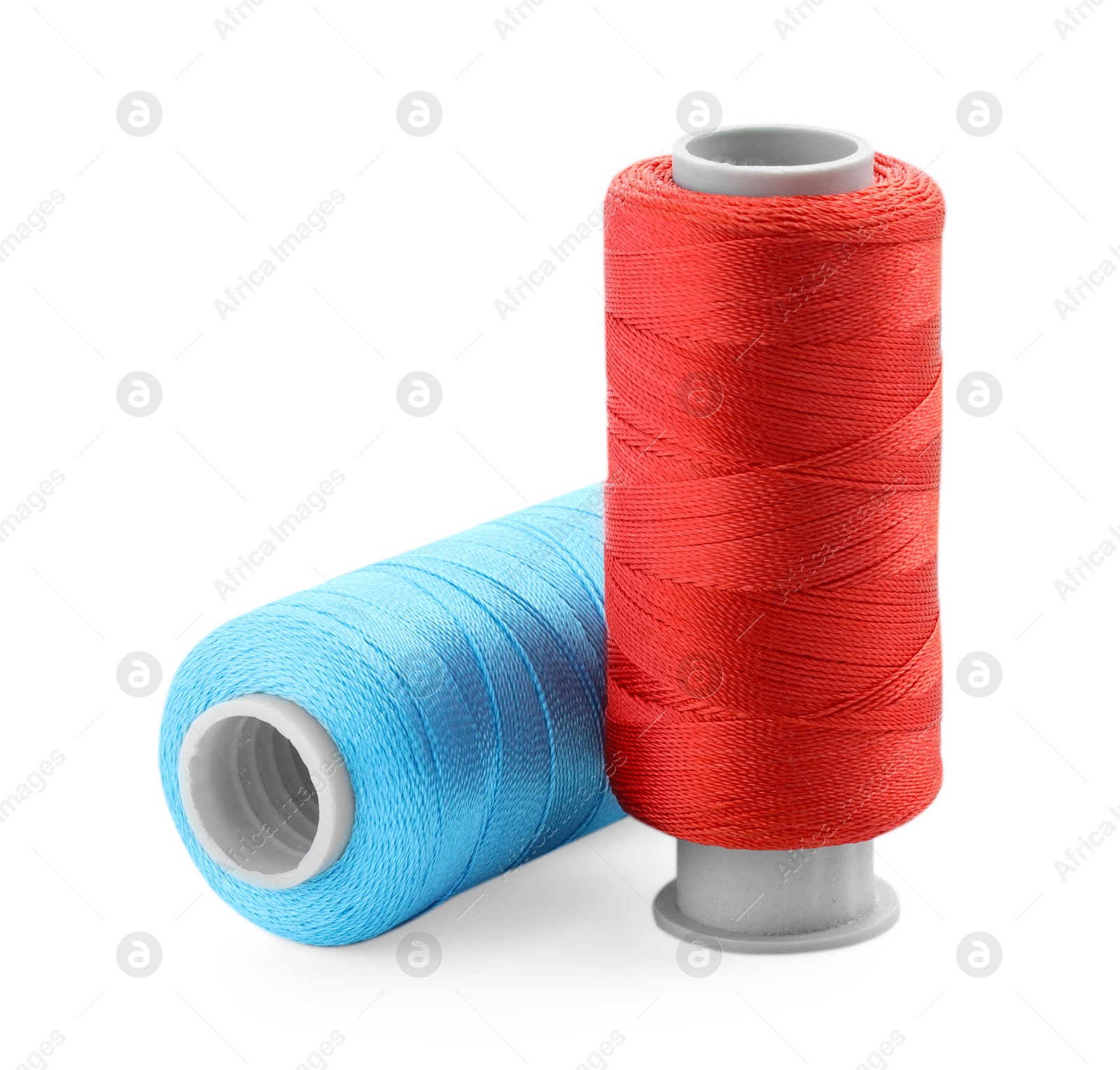 Photo of Spools of bright sewing threads isolated on white