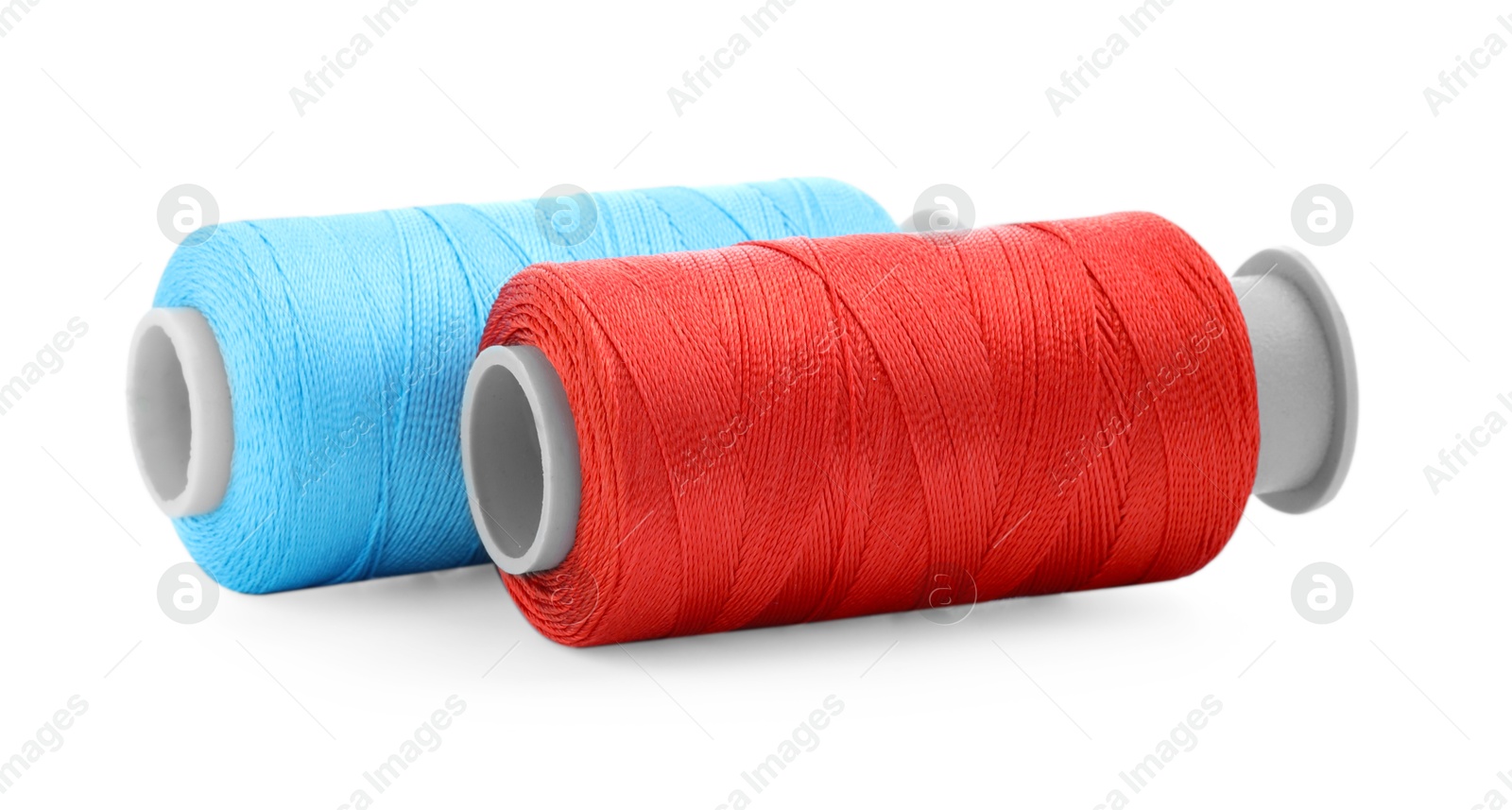 Photo of Spools of bright sewing threads isolated on white