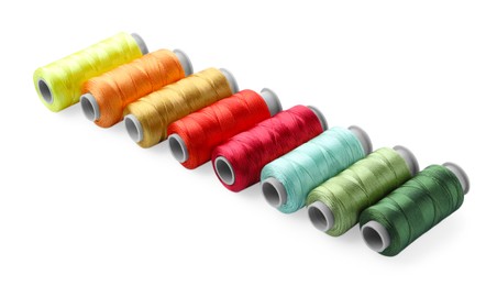 Photo of Spools of bright sewing threads isolated on white