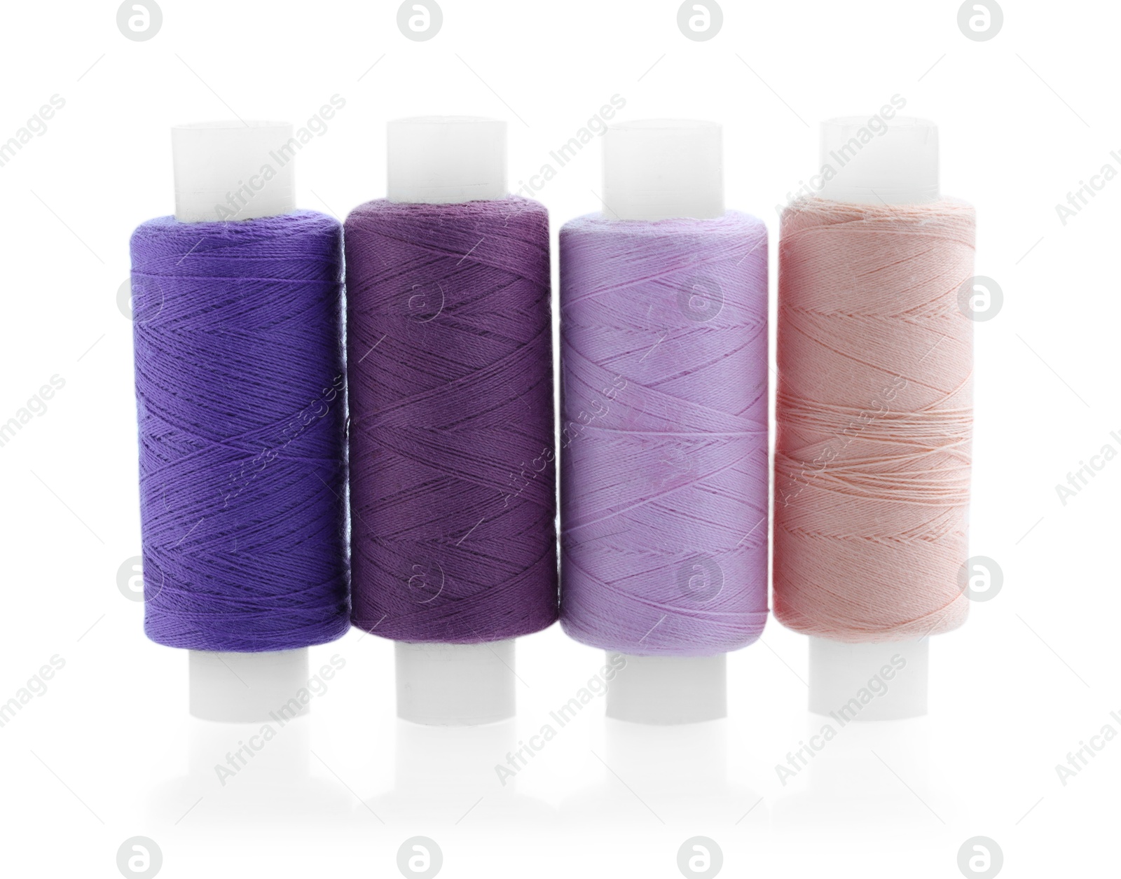 Photo of Spools of bright sewing threads isolated on white