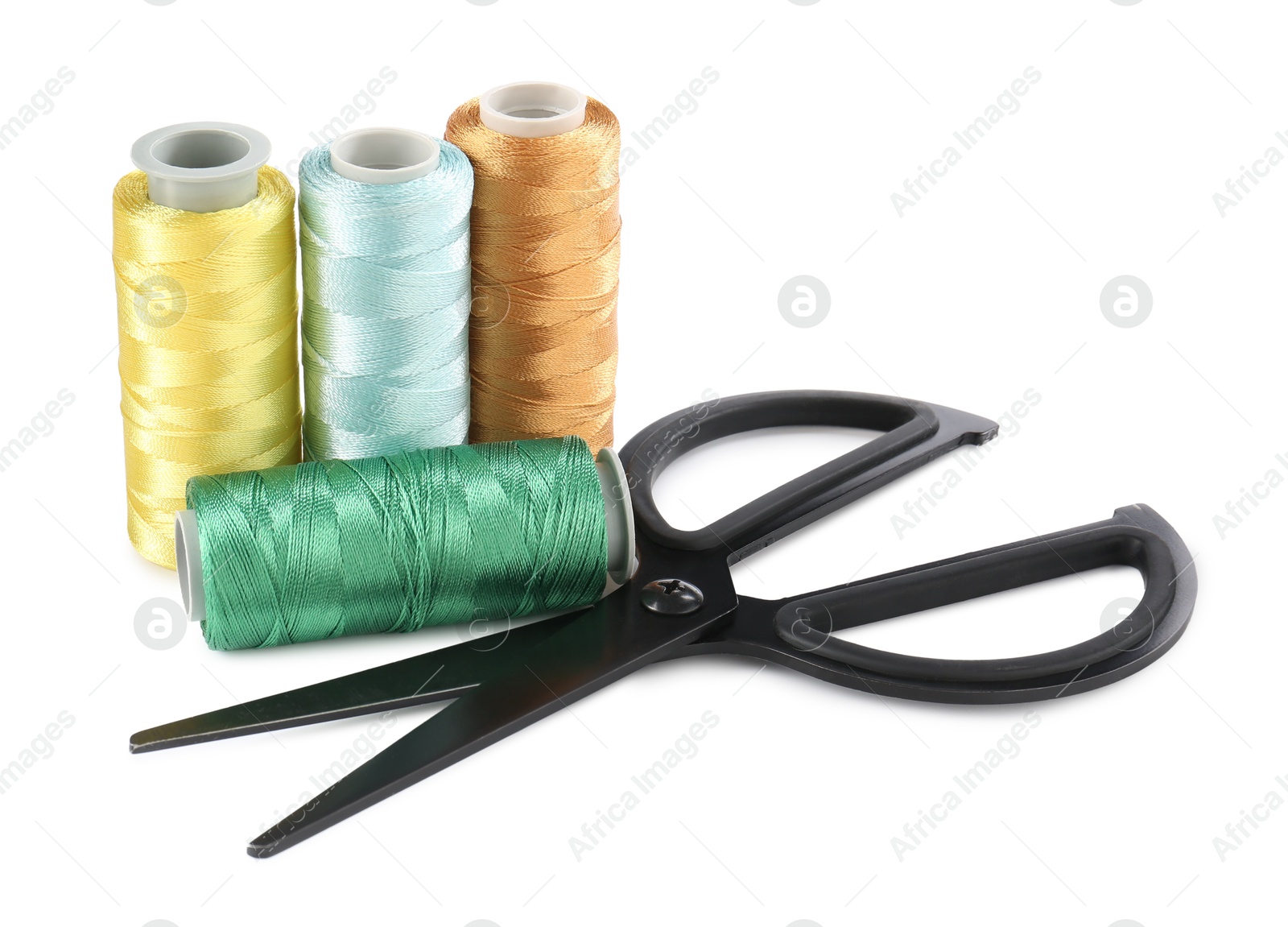 Photo of Spools of thread and scissors isolated on white. Sewing supplies