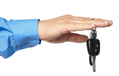 Man with car key and keychain on white background, closeup