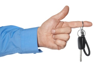 Man with car key and keychain on white background, closeup