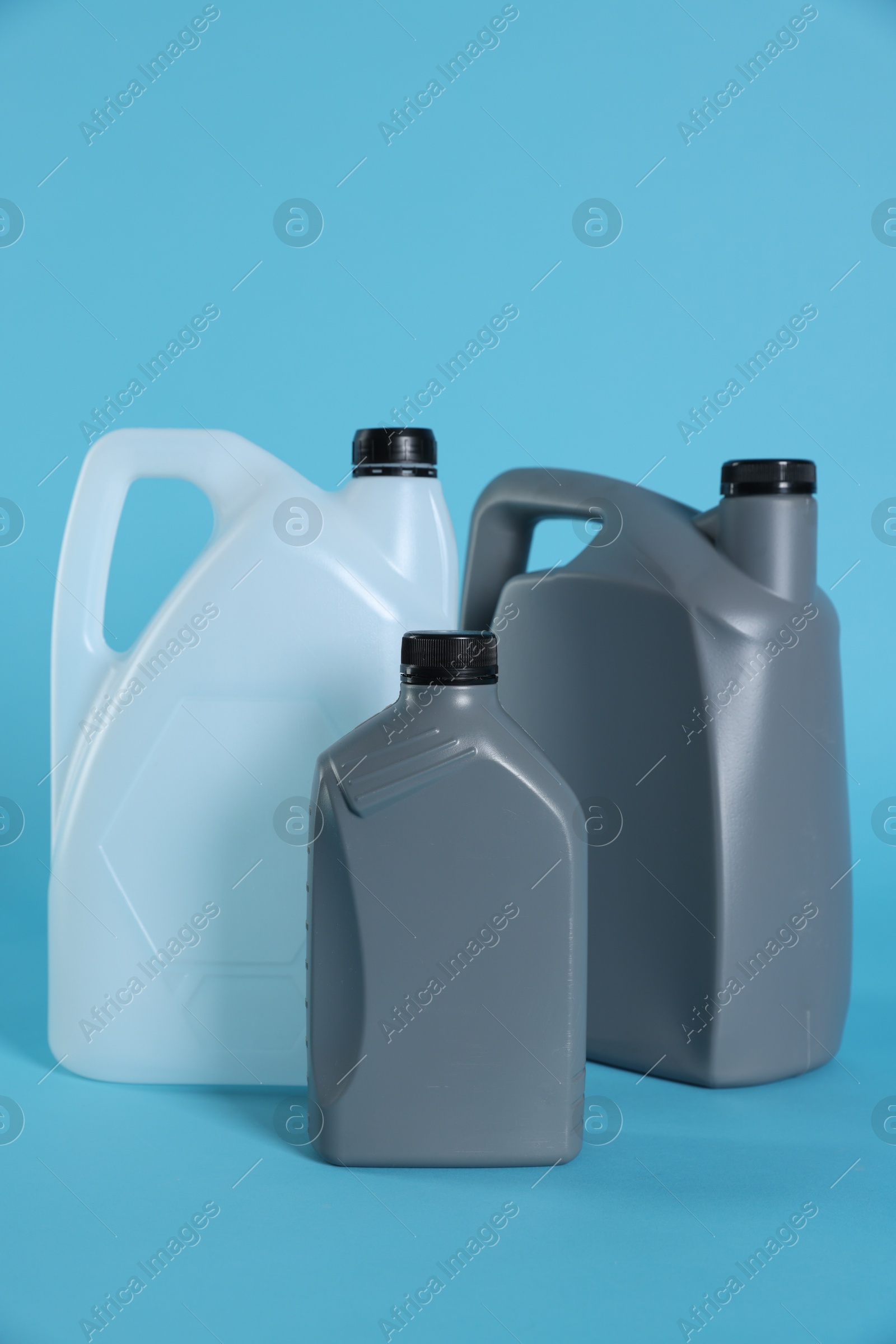 Photo of Different plastic canisters on light blue background