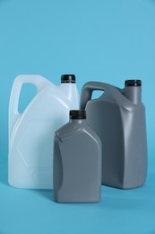 Photo of Different plastic canisters on light blue background