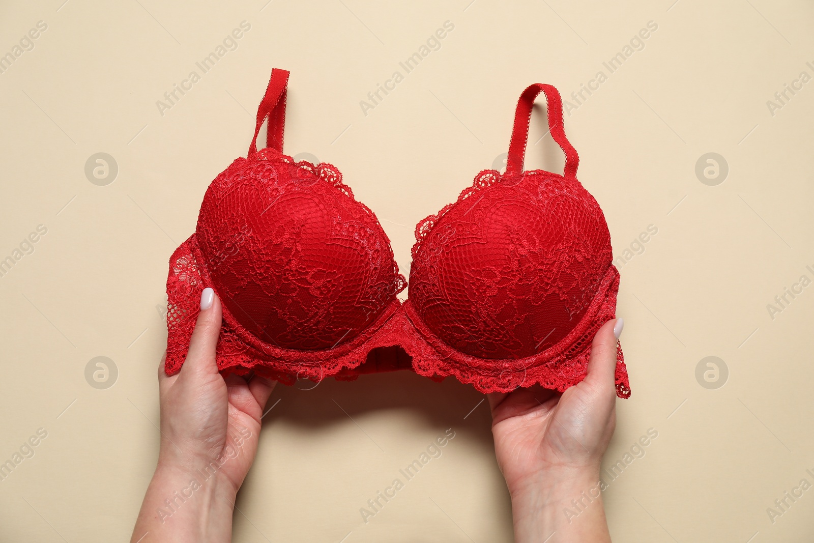 Photo of Woman with red bra on beige background, top view