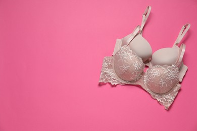 Photo of Beautiful bras on pink background, flat lay. Space for text