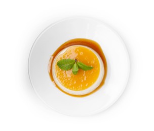 Photo of Tasty pudding with caramel sauce and mint isolated on white, top view