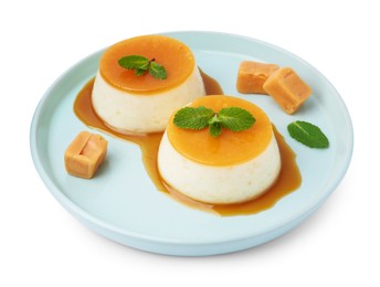 Photo of Tasty puddings with caramel sauce and mint isolated on white