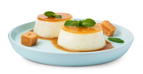 Photo of Tasty puddings with caramel sauce and mint isolated on white