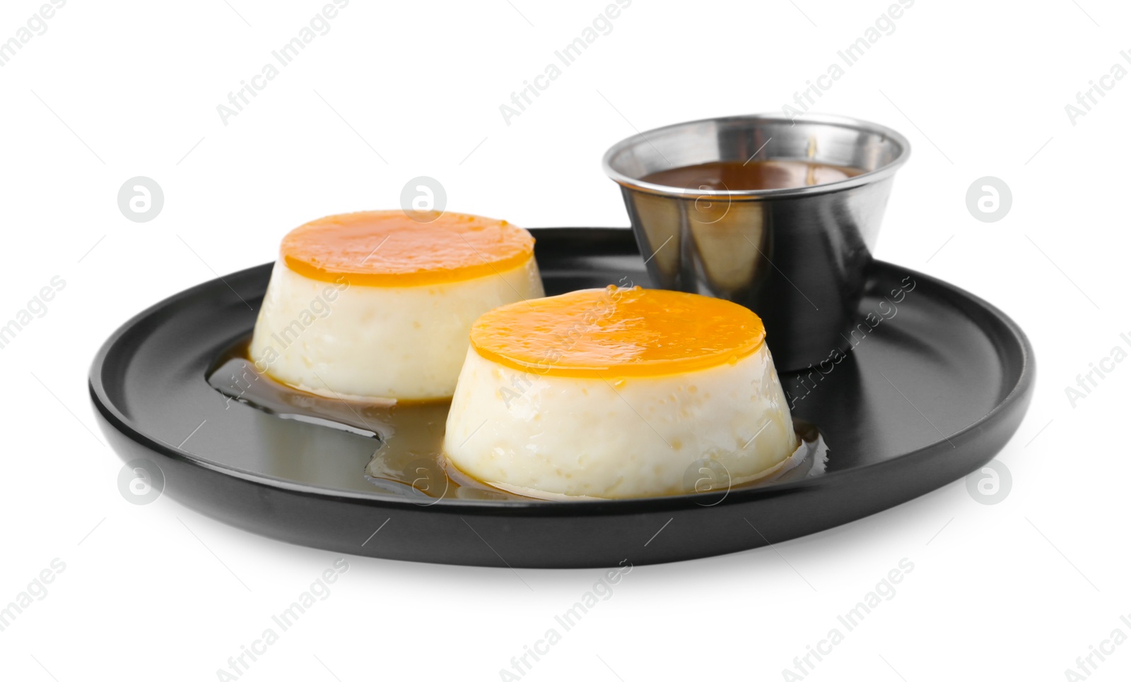 Photo of Tasty puddings with caramel sauce isolated on white