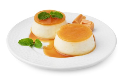 Photo of Tasty puddings with caramel sauce and mint isolated on white