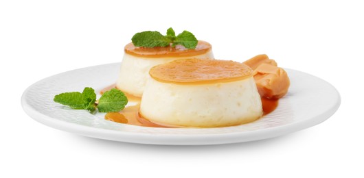 Photo of Tasty puddings with caramel sauce and mint isolated on white