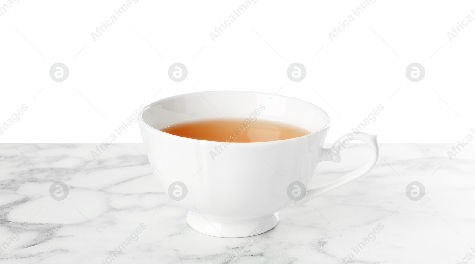 Photo of Refreshing green tea in cup on marble table against white background