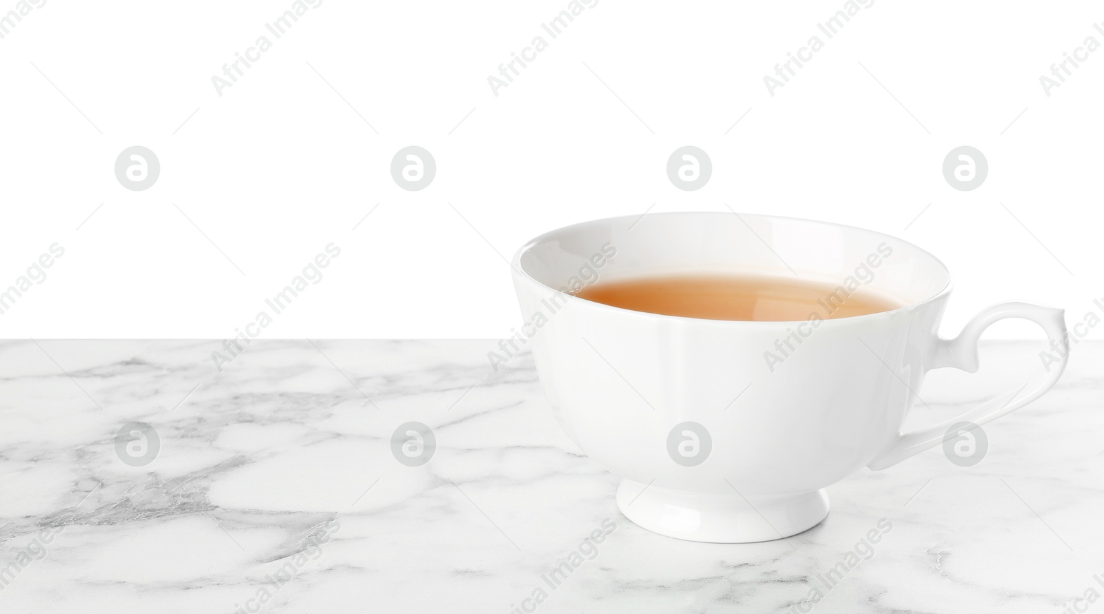 Photo of Refreshing green tea in cup on marble table against white background. Space for text