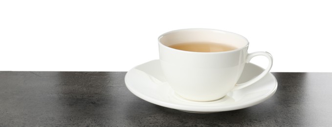 Refreshing green tea in cup on grey textured table against white background. Space for text