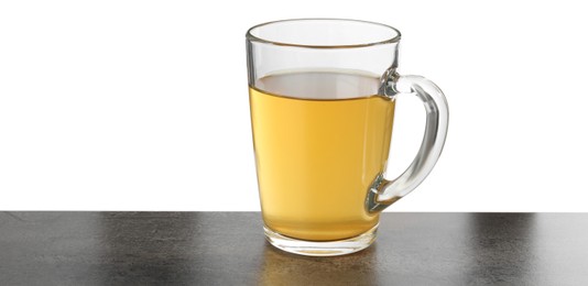 Refreshing green tea in cup on grey textured table against white background