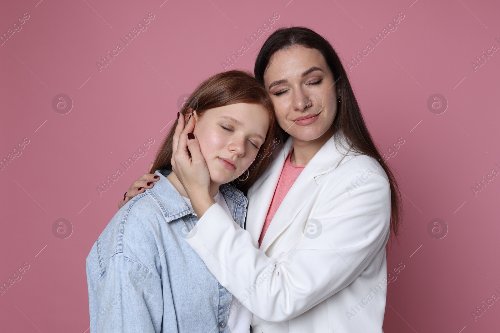 Photo of Family portrait of beautiful mother with teenage daughter on pink background