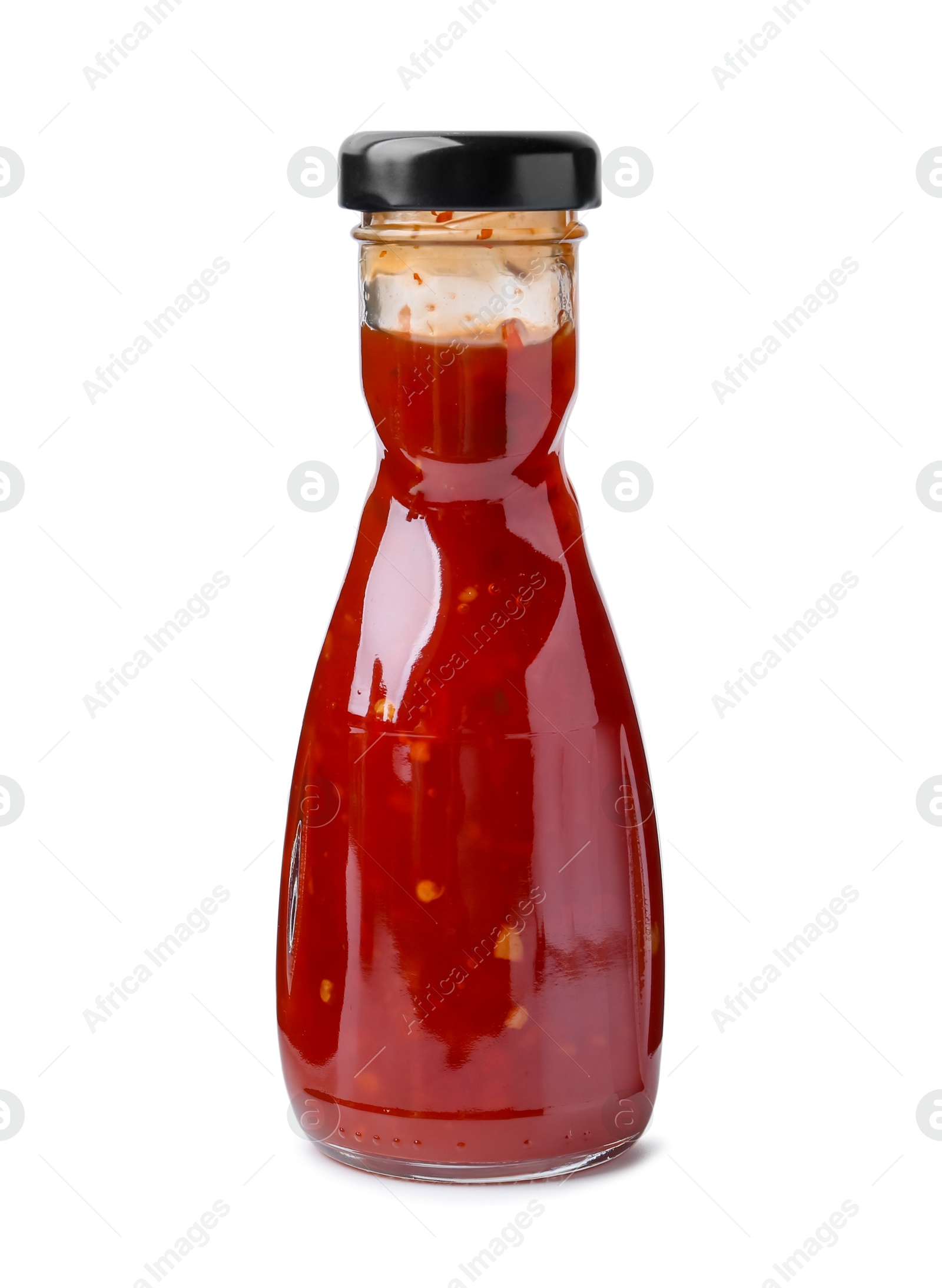 Photo of Delicious sauce in glass bottle isolated on white