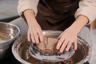 Photo of Hobby and craft. Woman making pottery indoors, closeup