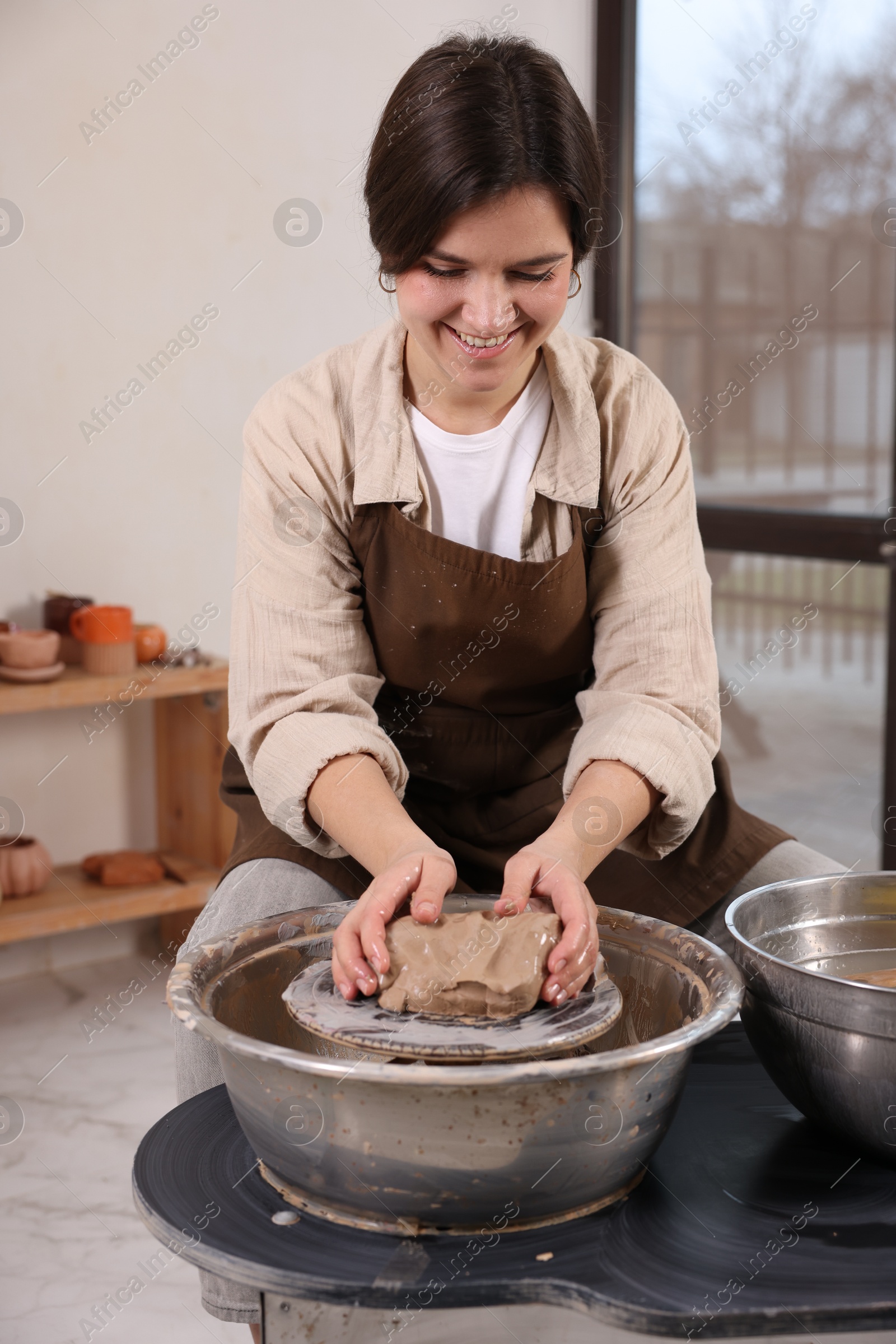 Photo of Hobby and craft. Smiling woman making pottery indoors