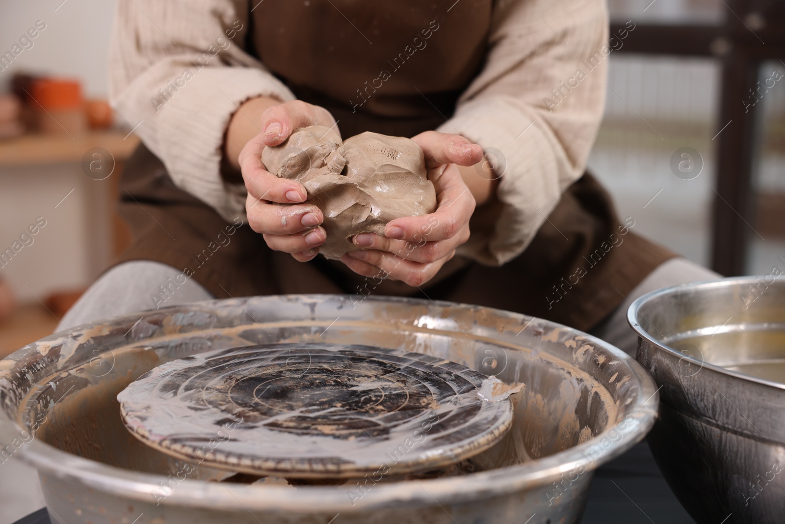 Photo of Hobby and craft. Woman making pottery indoors, closeup