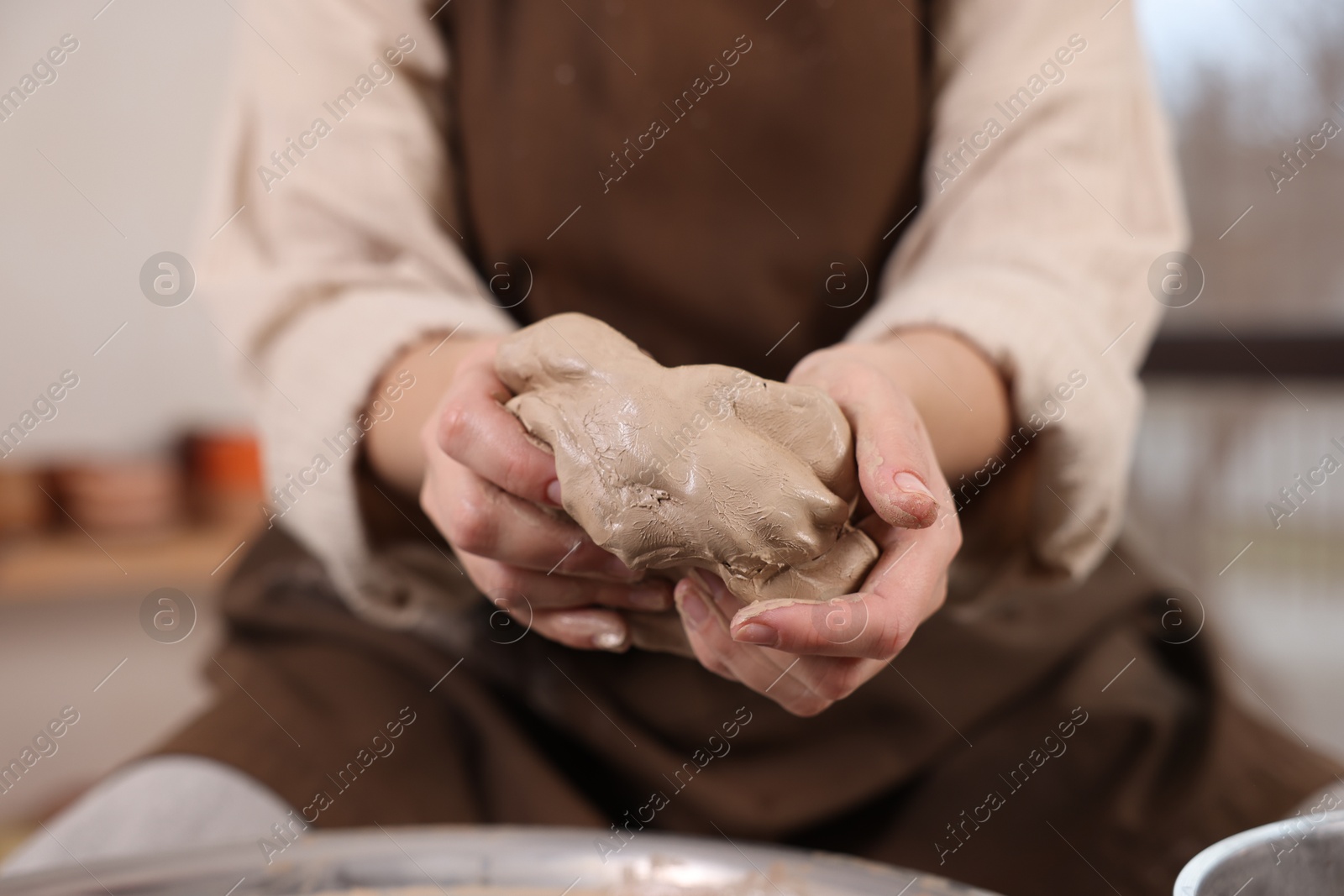 Photo of Hobby and craft. Woman making pottery indoors, closeup