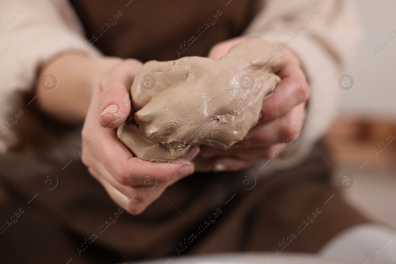 Photo of Hobby and craft. Woman making pottery indoors, closeup