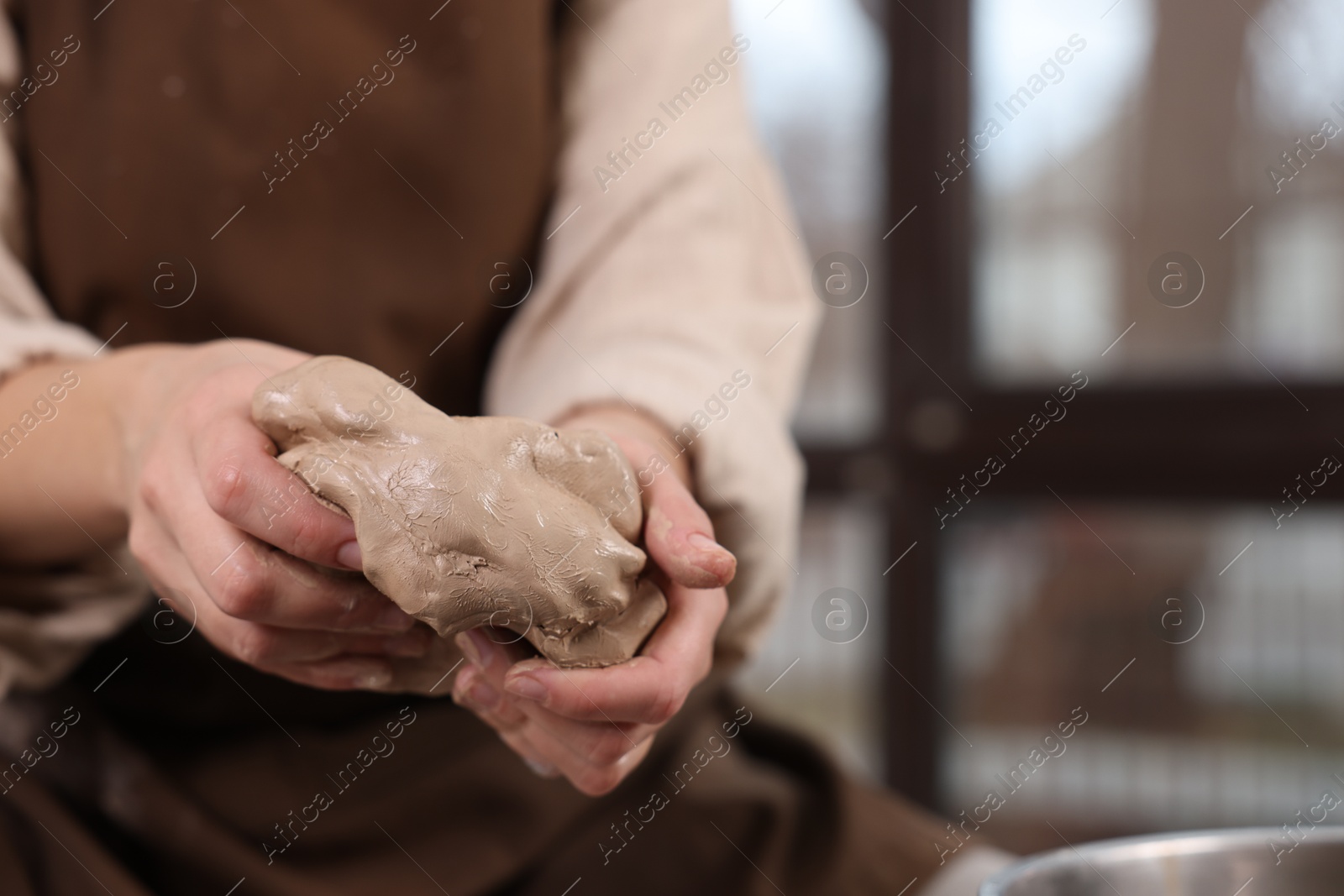 Photo of Hobby and craft. Woman making pottery indoors, closeup. Space for text