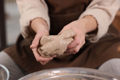 Photo of Hobby and craft. Woman making pottery indoors, closeup