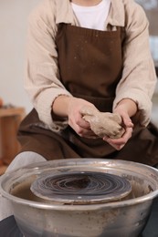 Photo of Hobby and craft. Woman making pottery indoors, closeup