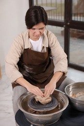 Photo of Hobby and craft. Woman making pottery indoors