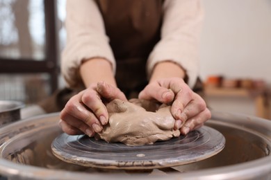 Photo of Hobby and craft. Woman making pottery indoors, closeup