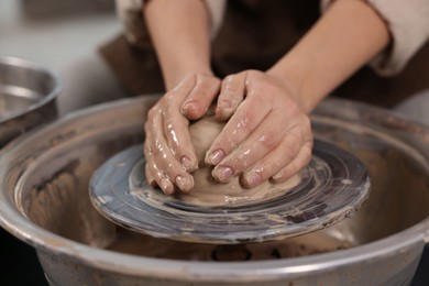 Photo of Hobby and craft. Woman making pottery indoors, closeup