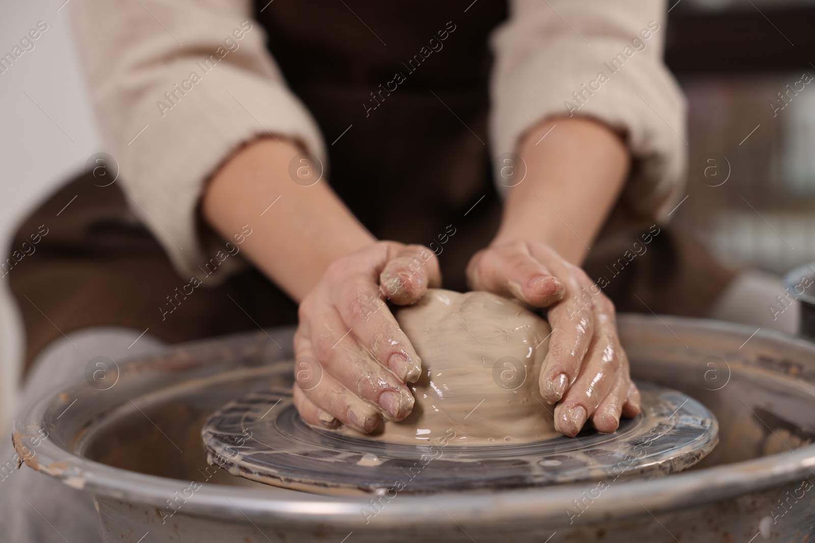 Photo of Hobby and craft. Woman making pottery indoors, closeup