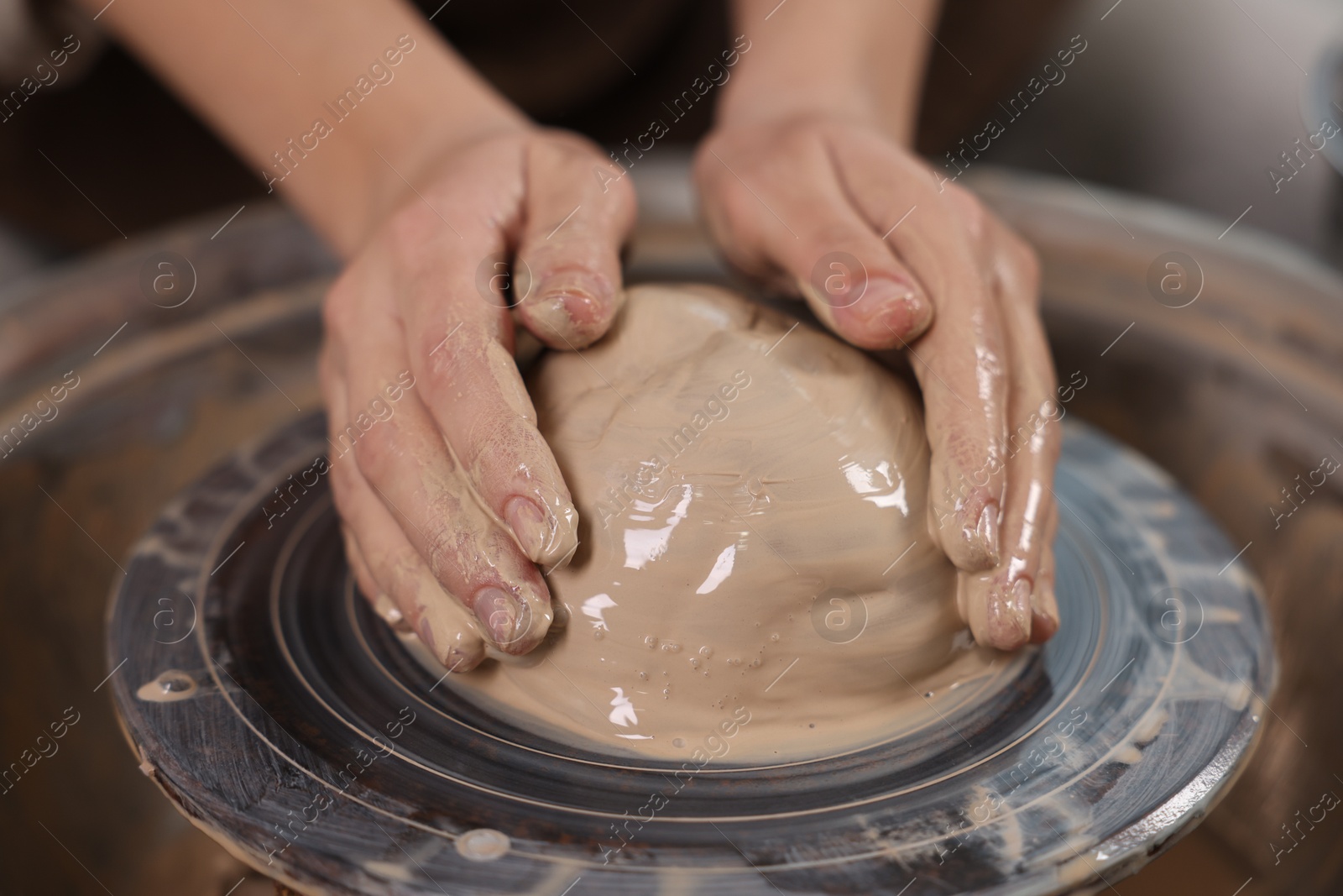 Photo of Hobby and craft. Woman making pottery indoors, closeup