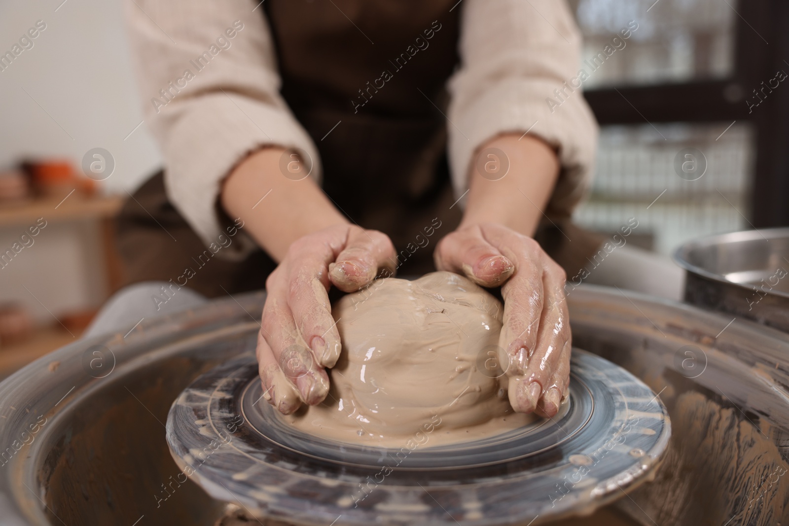 Photo of Hobby and craft. Woman making pottery indoors, closeup