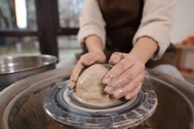 Photo of Hobby and craft. Woman making pottery indoors, closeup