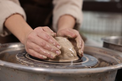 Photo of Hobby and craft. Woman making pottery indoors, closeup